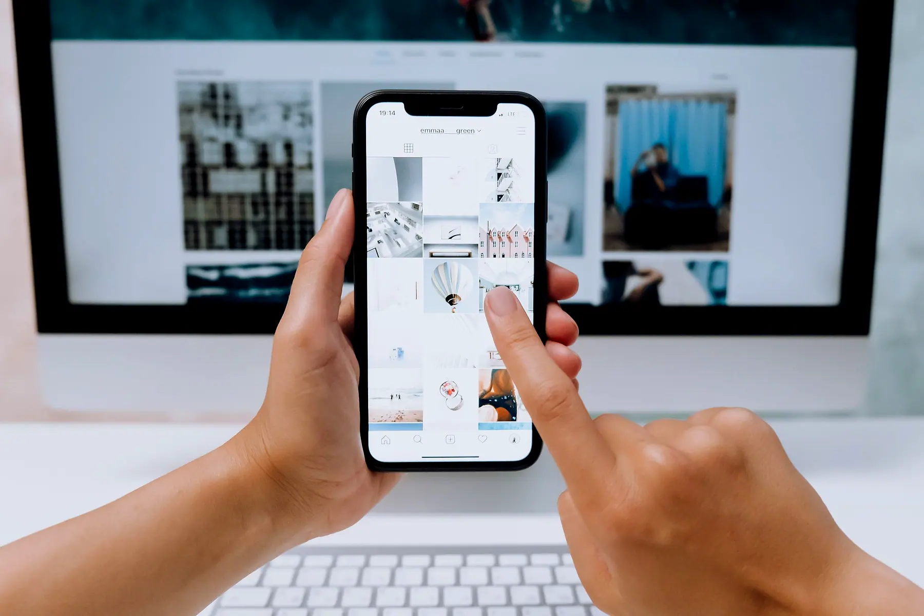A person scrolling a social media feed on a phone