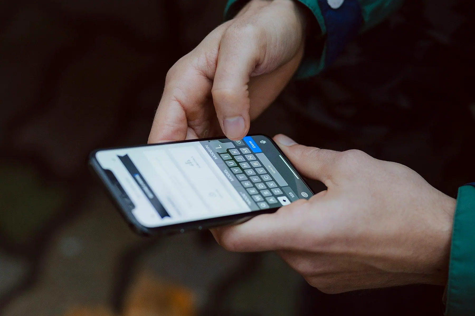 A person typing a reply to a message on a phone