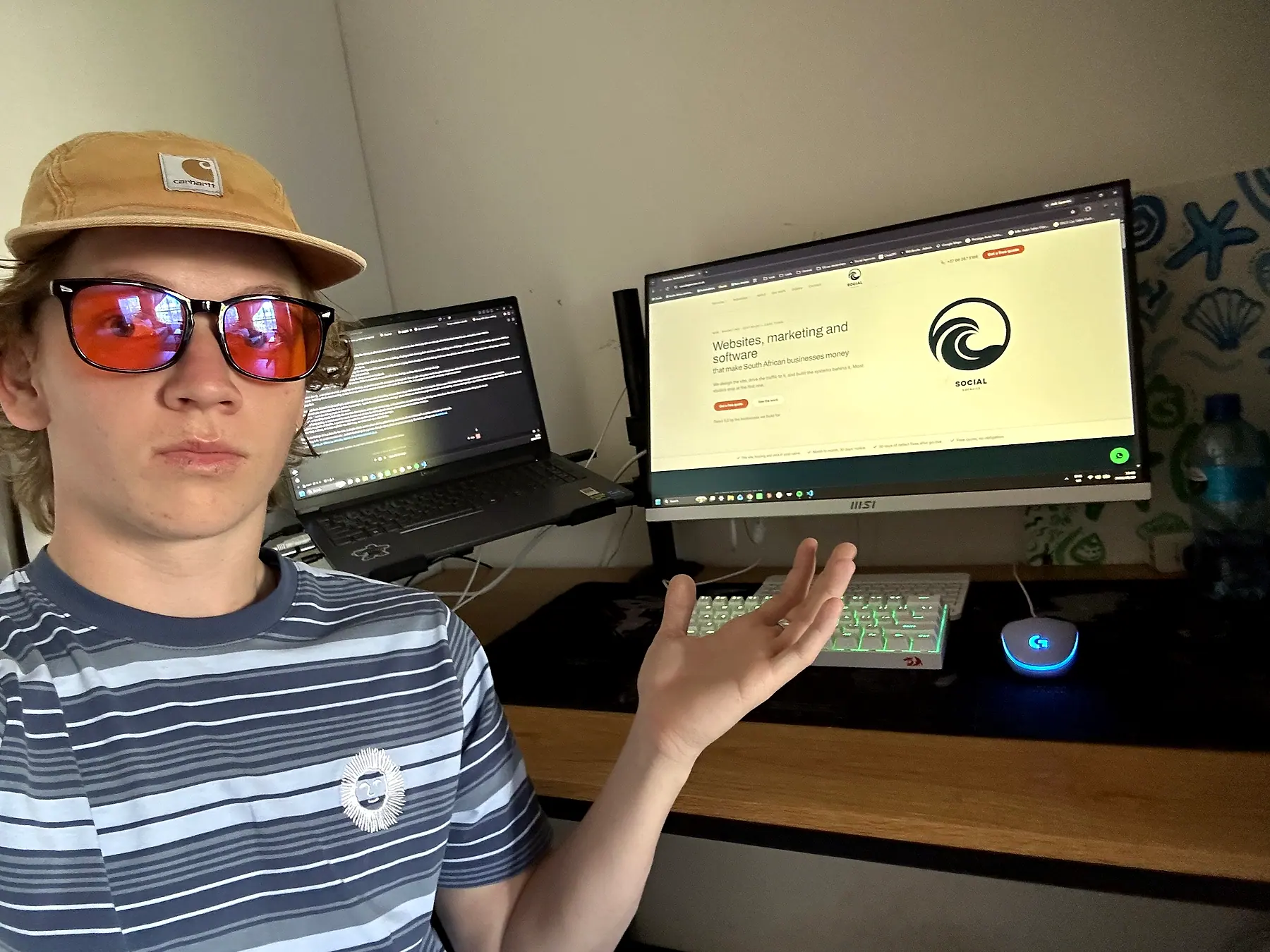 Jared, co-founder of Social Agencies, at his desk with the Social Agencies website on his monitor