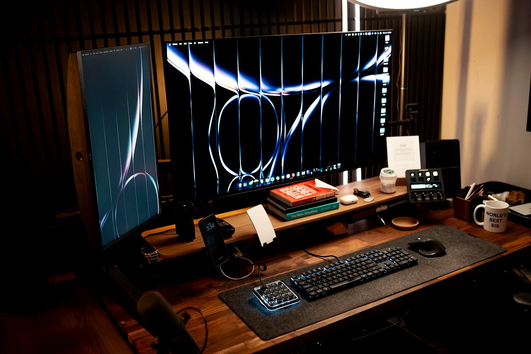 A studio desk at night with an ultrawide and a vertical monitor